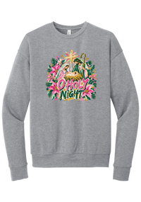 Artful O Holy Night crewneck sweatshirt in Athletic Heather, featuring a painted nativity under the star of Bethlehem with O Holy Night lettering framed by pink poinsettias and evergreen