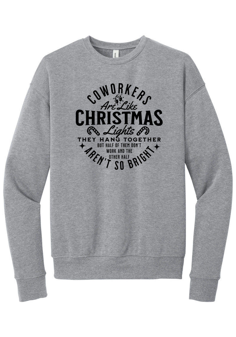 Coworkers Are Like Christmas Lights crewneck sweatshirt in Athletic Heather, featuring bold black type reading Coworkers Are Like Christmas Lights, they hang together but half of them don't work and the other half aren't so bright