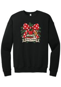 Merry Teachmas crewneck sweatshirt in Black, featuring a red polka dot bow over a stack of books reading Teach, Inspire, Change with an apple, pencils, evergreen, and a Merry Teachmas banner