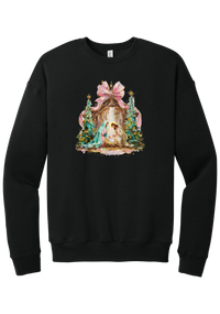 Painterly Nativity crewneck sweatshirt in Black, featuring a painterly nativity scene with Mary, Joseph, and baby Jesus in a wooden stable between teal Christmas trees and a pink bow