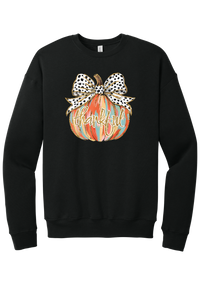 Thankful Pumpkin Bow crewneck sweatshirt in Black, featuring a painted pumpkin with a spotted bow and thankful in gold glitter script