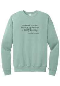 Amelia Earhart Tenacity Quote crewneck sweatshirt in Dusty Blue, featuring The most difficult thing is the decision to act the rest is merely tenacity in distressed black typewriter letters