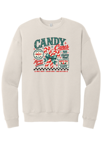 Fresh Candy Canes crewneck sweatshirt in Heather Dust, featuring vintage candy shop lettering with two striped candy canes tied in a green bow, a North Pole Peppermint Goodness sign, and a checkerboard stripe