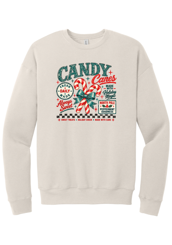 Fresh Candy Canes crewneck sweatshirt in Heather Dust, featuring vintage candy shop lettering with two striped candy canes tied in a green bow, a North Pole Peppermint Goodness sign, and a checkerboard stripe