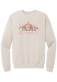 The Greatest Gift of All crewneck sweatshirt in Heather Dust, featuring a pastel watercolor nativity scene under the star with The Greatest Gift of All script and Matthew 1:21