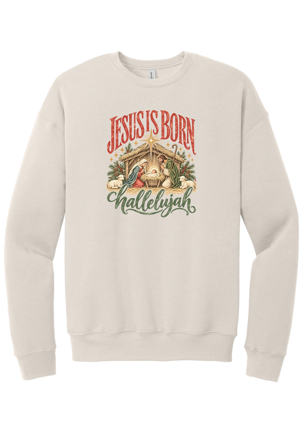 Jesus Is Born Hallelujah crewneck sweatshirt in Heather Dust, featuring a vintage nativity scene under a golden star with Jesus Is Born lettering and Hallelujah script