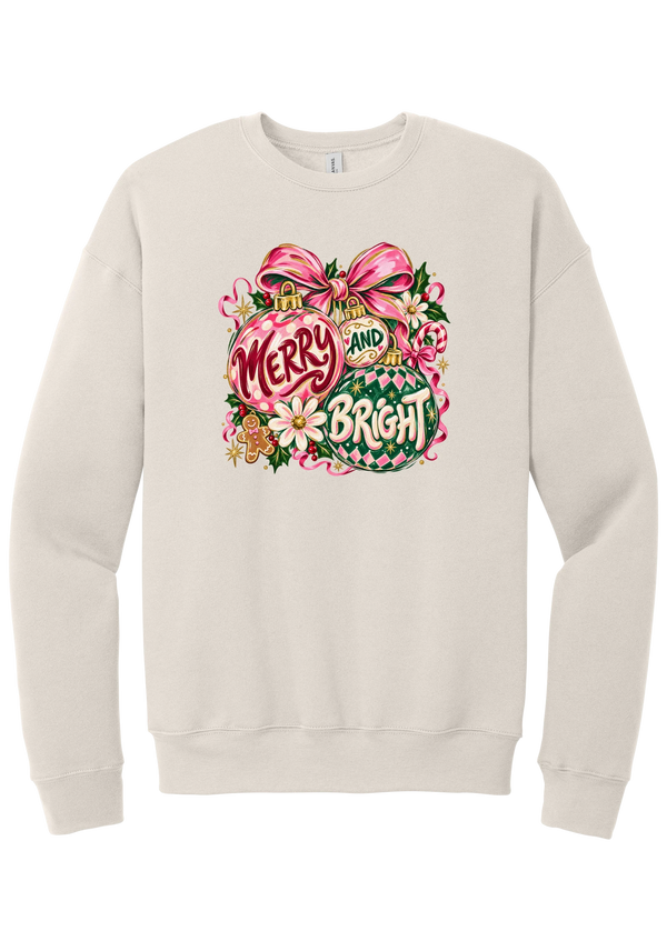 Merry and Bright Ornaments crewneck sweatshirt in Heather Dust, featuring hand-painted pink and green ornaments reading Merry and Bright with a pink bow, holly, daisies, a candy cane, and a gingerbread man