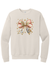 Nativity Bow crewneck sweatshirt in Heather Dust, featuring a blush satin bow with painted nativity scenes in its ribbons and gold snowflakes