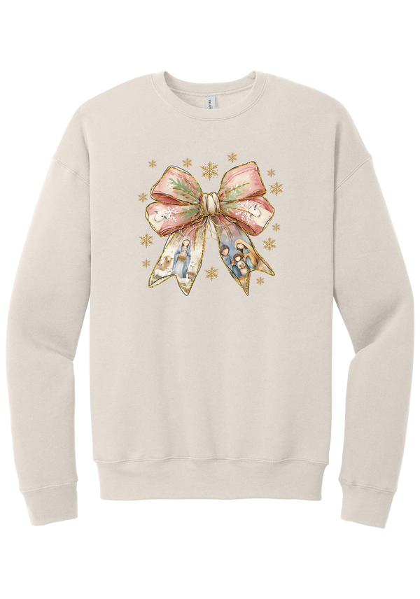 Nativity Bow crewneck sweatshirt in Heather Dust, featuring a blush satin bow with painted nativity scenes in its ribbons and gold snowflakes