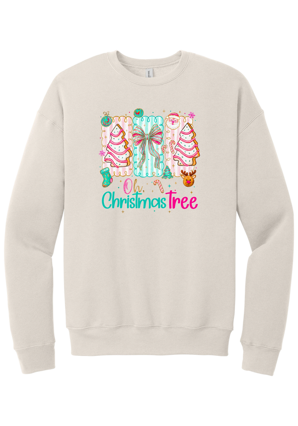 Oh Christmas Tree Cakes crewneck sweatshirt in Heather Dust, featuring frosted Christmas tree snack cakes on pink and mint panels over Oh Christmas Tree lettering