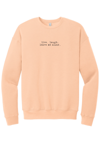 Live Laugh Leave Me Alone crewneck sweatshirt in Peach, featuring live. laugh. leave me alone. in distressed black typewriter letters