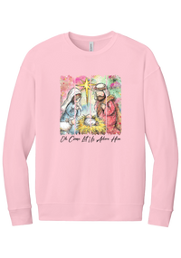 Adore Him Painted Nativity crewneck sweatshirt in Pink, featuring a watercolor nativity of Mary, Joseph, and baby Jesus under a star with Oh Come Let Us Adore Him script
