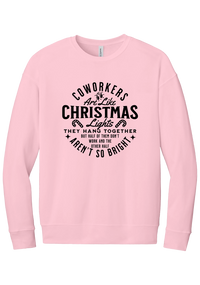 Coworkers Are Like Christmas Lights crewneck sweatshirt in Pink, featuring bold black type reading Coworkers Are Like Christmas Lights, they hang together but half of them don't work and the other half aren't so bright