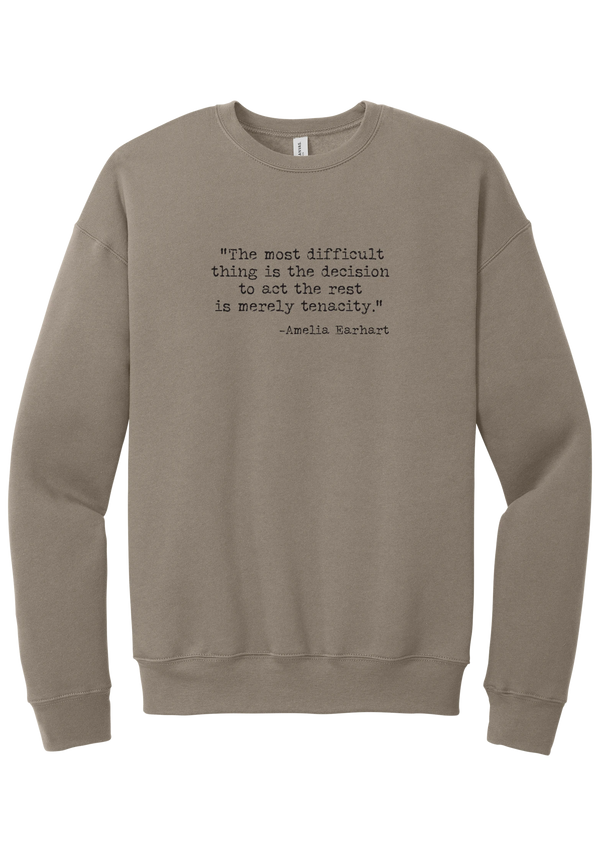 Amelia Earhart Tenacity Quote crewneck sweatshirt in Tan, featuring The most difficult thing is the decision to act the rest is merely tenacity in distressed black typewriter letters