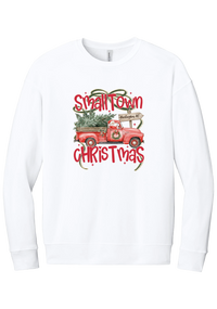 Personalized Small Town Christmas crewneck sweatshirt in White, featuring Santa in a vintage red pickup truck hauling a Christmas tree past a personalized town road sign, with red Small Town Christmas lettering