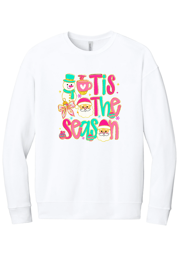 Tis the Season Snowman crewneck sweatshirt in White, featuring pink and teal TIS THE SEASON letters with a snowman, a cocoa mug, and Santas