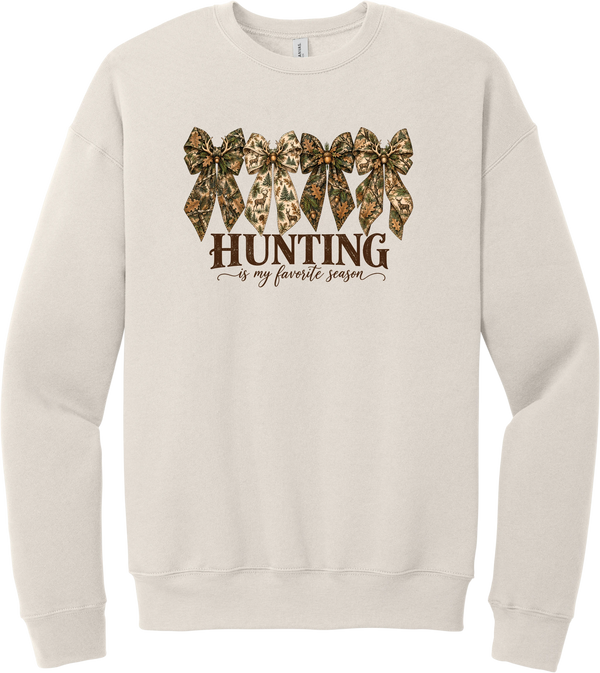 Hunting Is My Favorite Season crewneck sweatshirt in Heather Dust, featuring four camo coquette bows with antlers, acorns, and deer above Hunting Is My Favorite Season lettering