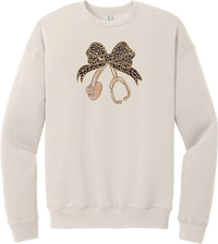 Leopard Bow Stethoscope crewneck sweatshirt in Heather Dust, featuring a glittery leopard print coquette bow tied to a rose gold stethoscope