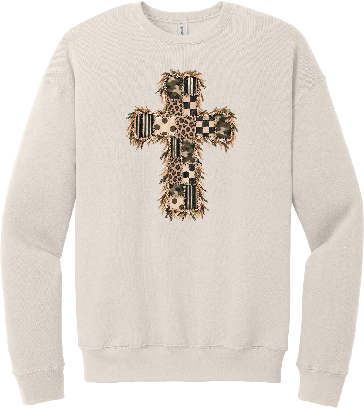 Quilted Patchwork Cross crewneck sweatshirt in Heather Dust, featuring a patchwork cross in camo, leopard, checkerboard, polka dot, and stripes with a fringed edge