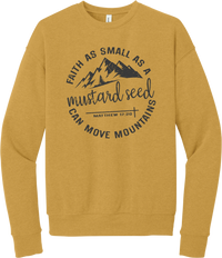 Mustard Seed Faith crewneck sweatshirt in Heather Mustard, featuring a circle badge of mountains and a cross with Faith as Small as a Mustard Seed Can Move Mountains lettering and Matthew 17:20