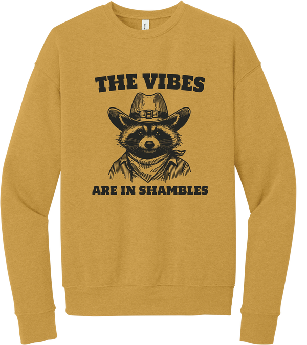 The Vibes Are in Shambles crewneck sweatshirt in Heather Mustard, featuring a cowboy raccoon in a bandana with The vibes are in shambles