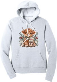 Highland Holidays hoodie in Ash, featuring a fluffy baby Highland cow in a Fair Isle knit scarf, surrounded by frosted eucalyptus, pine, red berries, and white Christmas roses