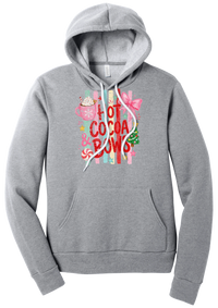 Hot Cocoa and Bows hoodie in Athletic Heather, featuring red HOT COCOA and BOWS letters on pastel stripes with a cocoa mug and a pink bow