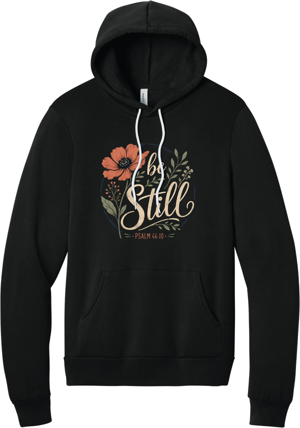 Be Still hoodie in Black, featuring Be Still in hand lettered script with a coral poppy, greenery, and Psalm 46:10