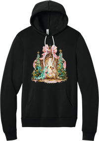 Painterly Nativity hoodie in Black, featuring a painterly nativity scene with Mary, Joseph, and baby Jesus in a wooden stable between teal Christmas trees and a pink bow