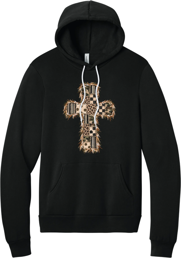 Quilted Patchwork Cross hoodie in Black, featuring a patchwork cross in camo, leopard, checkerboard, polka dot, and stripes with a fringed edge