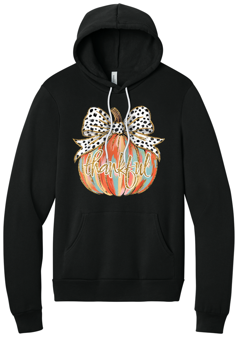 Thankful Pumpkin Bow hoodie in Black, featuring a painted pumpkin with a spotted bow and thankful in gold glitter script
