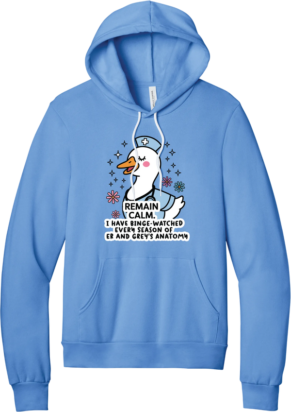 Remain Calm Nurse hoodie in Carolina Blue, featuring a smiling nurse goose in a cap and scrubs with sparkles and flowers above Remain Calm text