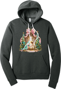 Painterly Nativity hoodie in Dark Grey Heather, featuring a painterly nativity scene with Mary, Joseph, and baby Jesus in a wooden stable between teal Christmas trees and a pink bow