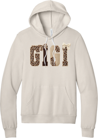 Grandma Leopard Applique hoodie in Heather Dust, featuring GIGI spelled out in leopard, cream, and chocolate patches with a scalloped stitched applique look and two bows