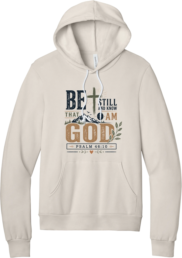 Be Still and Know hoodie in Heather Dust, featuring Be Still and Know That I Am God lettering with a cross over mountains and Psalm 46:10