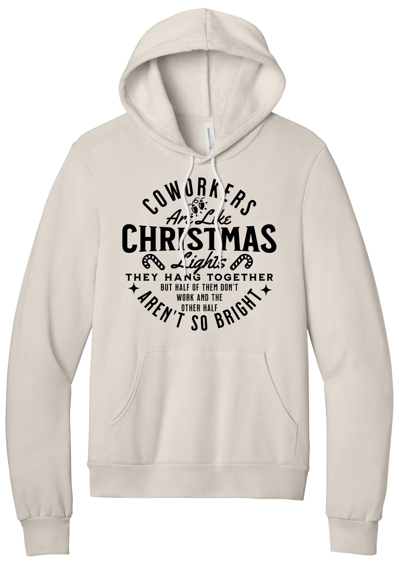 Coworkers Are Like Christmas Lights hoodie in Heather Dust, featuring bold black type reading Coworkers Are Like Christmas Lights, they hang together but half of them don't work and the other half aren't so bright