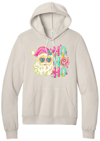 Ho Ho Ho Santa Portrait hoodie in Heather Dust, featuring a pink-hatted Santa in teal heart sunglasses with stacked HO HO HO letters