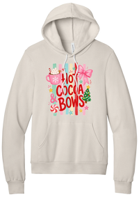Hot Cocoa and Bows hoodie in Heather Dust, featuring red HOT COCOA and BOWS letters on pastel stripes with a cocoa mug and a pink bow