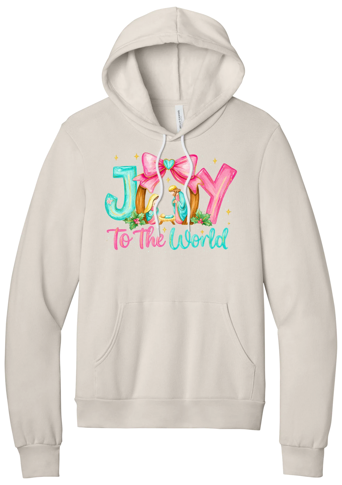 Joy to the World Nativity hoodie in Heather Dust, featuring painted JOY letters framing a nativity scene with a pink bow and To The World script