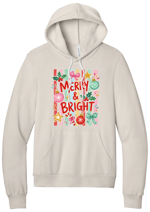 Merry and Bright Striped hoodie in Heather Dust, featuring red MERRY and BRIGHT letters on pink and green stripes with ornaments and holly