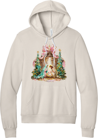 Painterly Nativity hoodie in Heather Dust, featuring a painterly nativity scene with Mary, Joseph, and baby Jesus in a wooden stable between teal Christmas trees and a pink bow