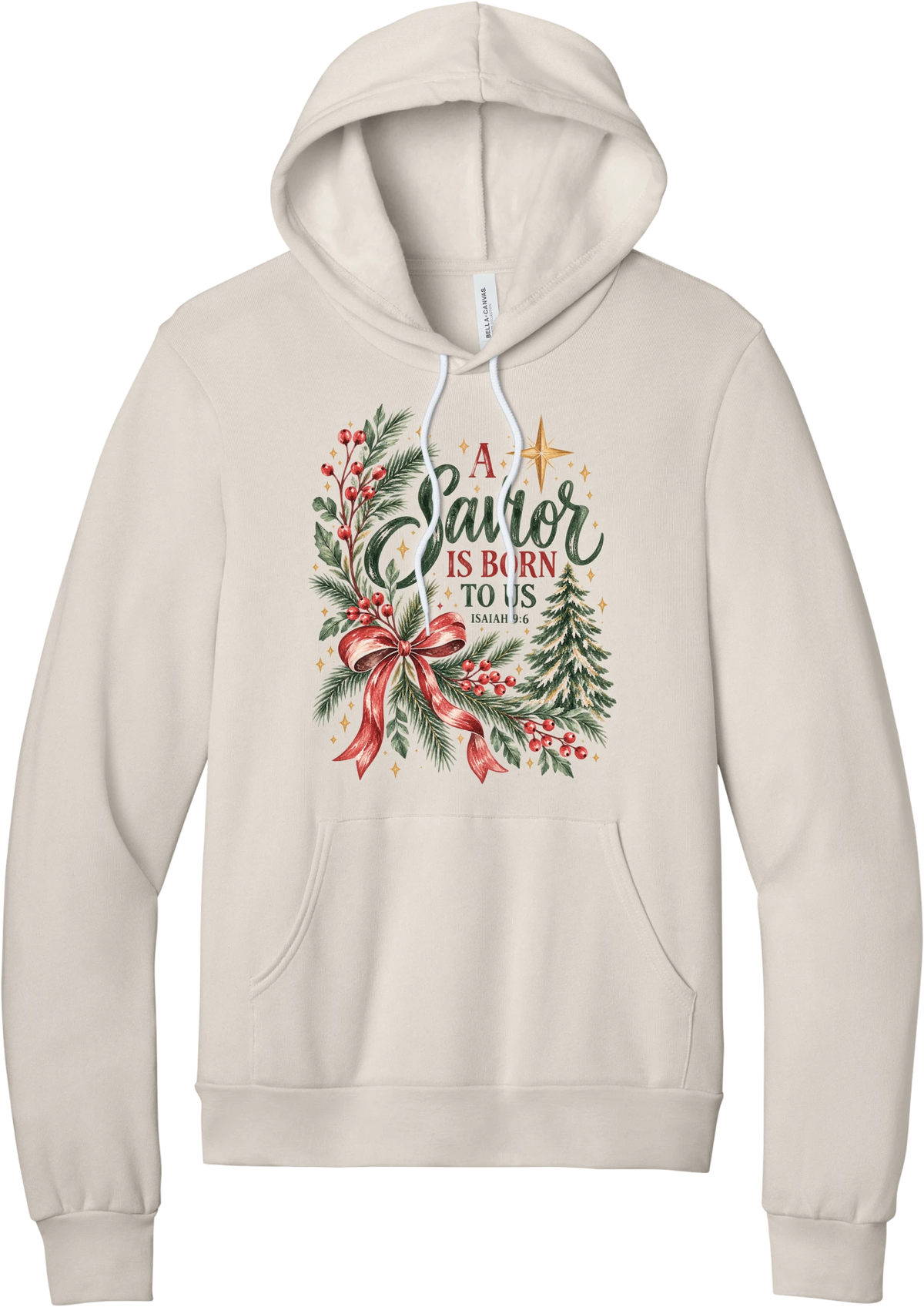A Savior Is Born To Us hoodie in Heather Dust, featuring watercolor evergreen and holly with a red ribbon bow, the words A Savior is born to us, and Isaiah 9:6