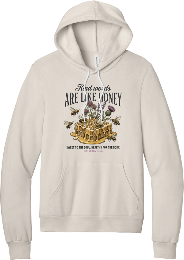 Words Like Honey hoodie in Heather Dust, featuring Kind Words Are Like Honey lettering over a dripping honeycomb with bees, wildflowers, and Proverbs 16:24