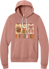Give Thanks Coquette hoodie in Mauve, featuring three bow-topped stamp panels with a turkey, stacked pumpkins, and a pink bow above Give Thanks in patchwork letters