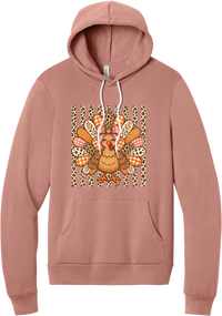 Preppy Turkey hoodie in Mauve, featuring a smiling turkey with gingham and leopard feathers and a pink bow on a leopard stripe background