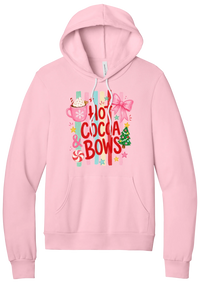 Hot Cocoa and Bows hoodie in Pink, featuring red HOT COCOA and BOWS letters on pastel stripes with a cocoa mug and a pink bow