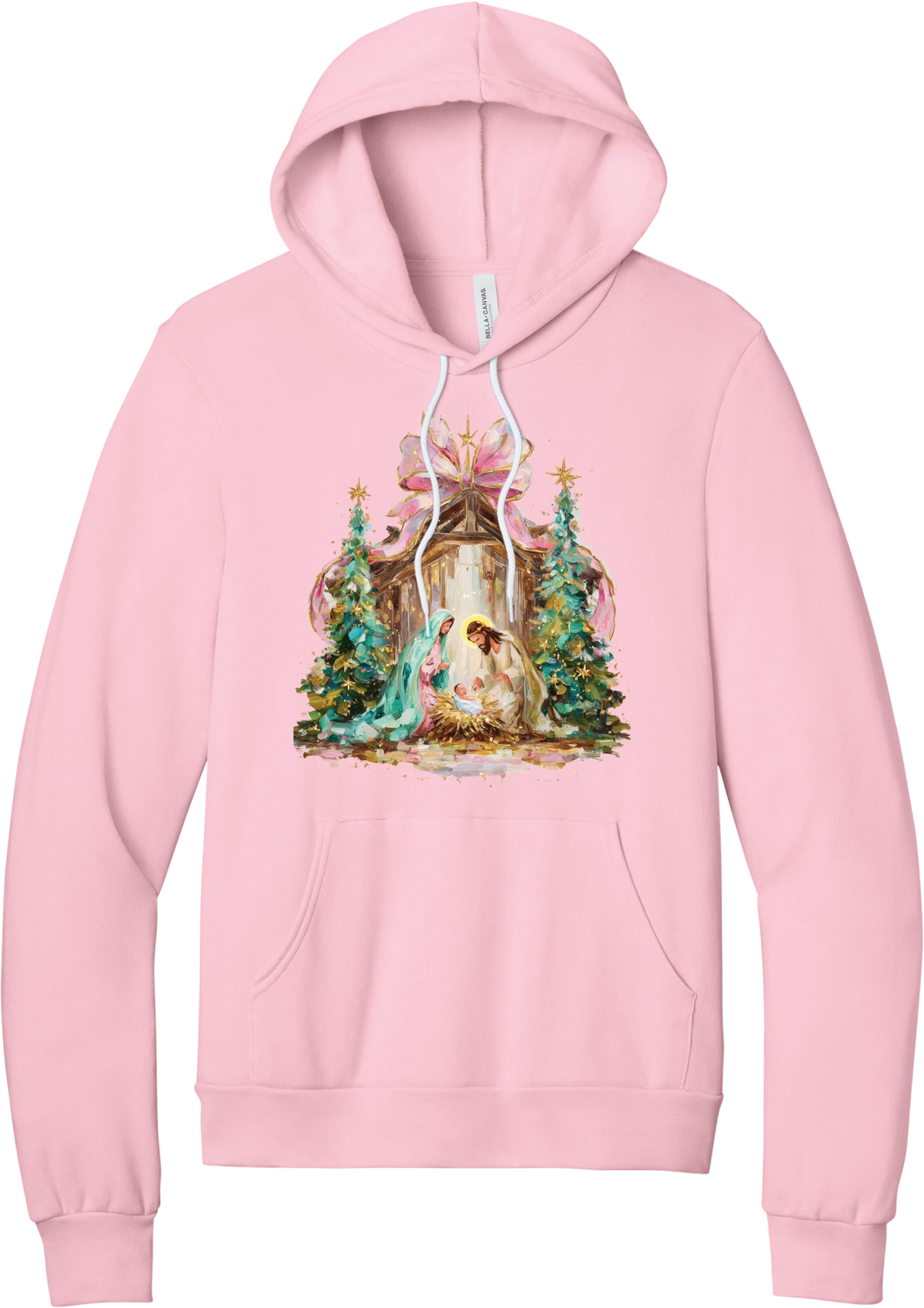Painterly Nativity hoodie in Pink, featuring a painterly nativity scene with Mary, Joseph, and baby Jesus in a wooden stable between teal Christmas trees and a pink bow