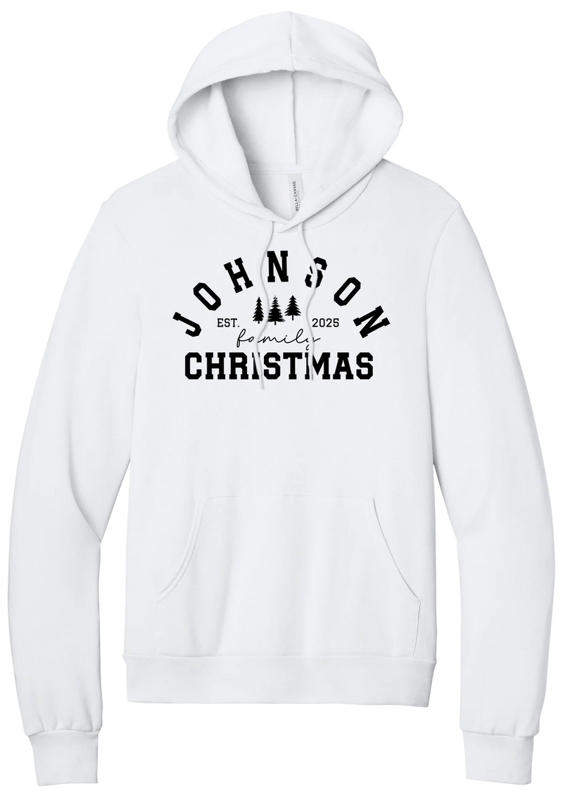 Personalized Family Christmas hoodie in White, featuring an arched family name over pine trees with EST. year and family Christmas lettering