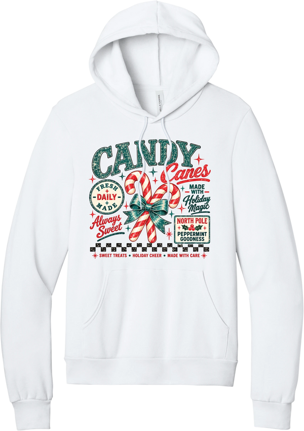 Fresh Candy Canes hoodie in White, featuring vintage candy shop lettering with two striped candy canes tied in a green bow, a North Pole Peppermint Goodness sign, and a checkerboard stripe