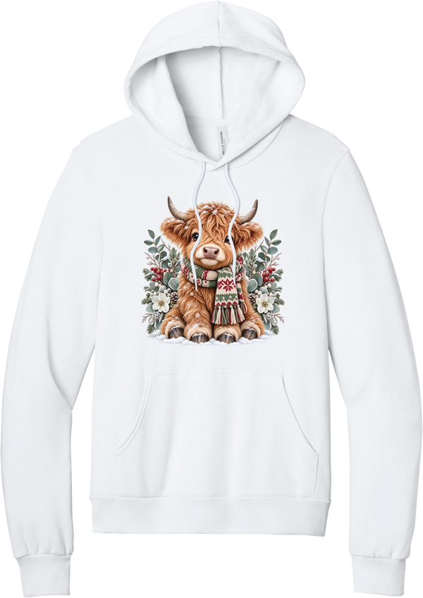 Highland Holidays hoodie in White, featuring a fluffy baby Highland cow in a Fair Isle knit scarf, surrounded by frosted eucalyptus, pine, red berries, and white Christmas roses